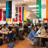 Idyllwild Arts Academy Photo #4 - Nelson Dining Hall, displaying flags of all the countries our students hail from, averaging over 30 different nations every year. Our dining hall provides 3 balanced hot meals per day, all made in house by our professional cooking staff. Additional options such as a sandwich bar, salad bar, and soup station are available at every meal.